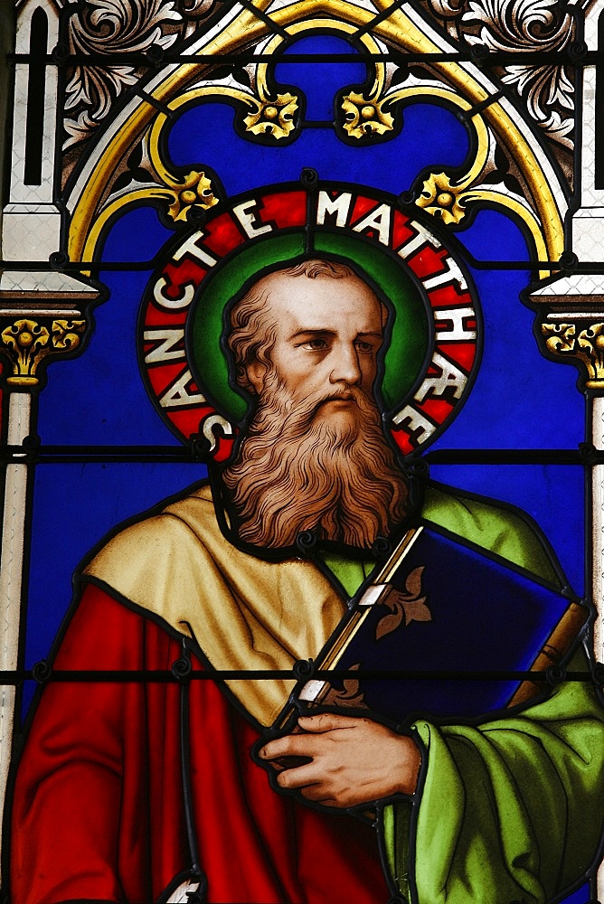 Stained glass window of St. Matthew at Collegiale Notre-Dame des Marais, Villefranche-sur-Saone, Rhones-Alpes, France, Europe