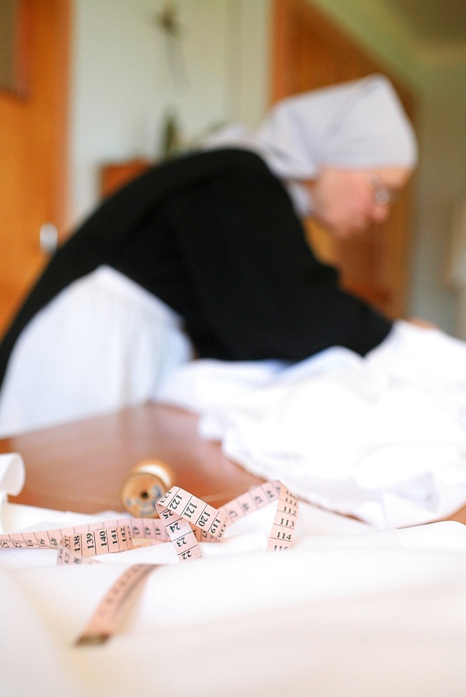 Benedictine nun making religious vestment, Urt, Pyrenees Atlantique, France, Europe