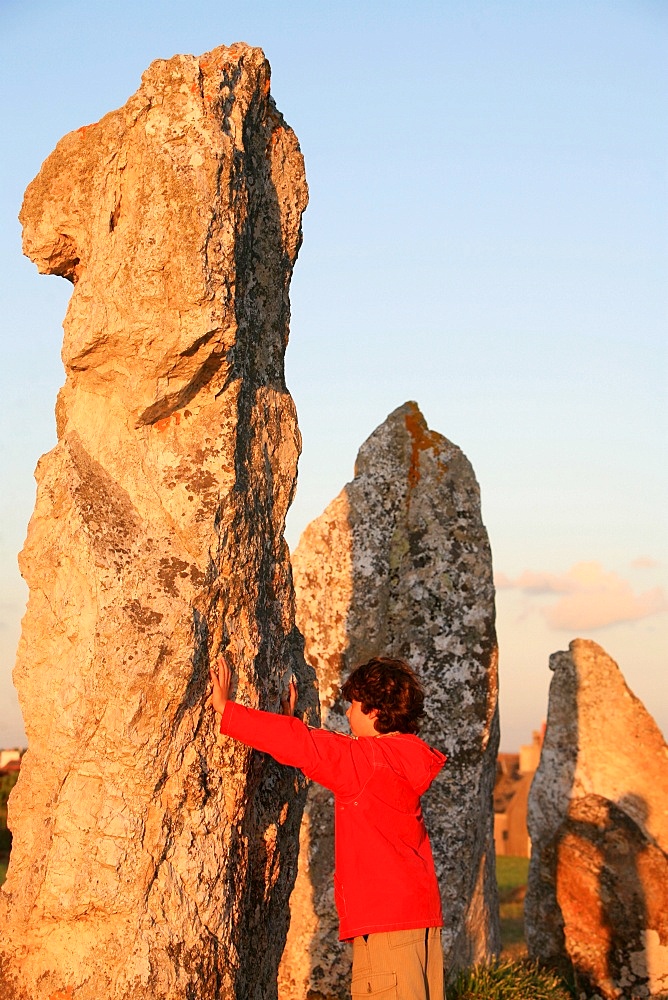 Boy with menhir, Camaret-sur-Mer, Finistere, Brittany, France, Europe