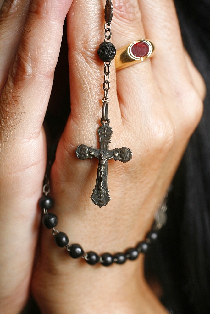 Woman praying with rosary