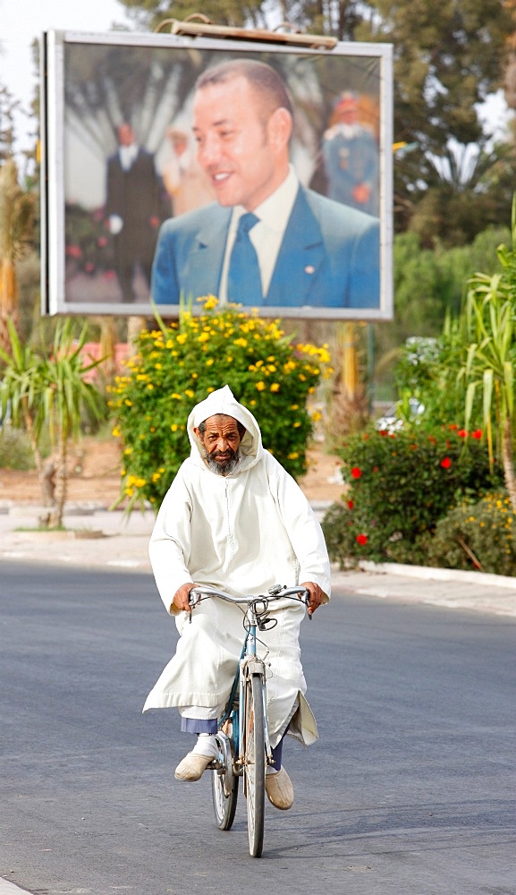 Portrait of King Mohammed VI and cyclist, Taroudan, Morocco, North Africa, Africa