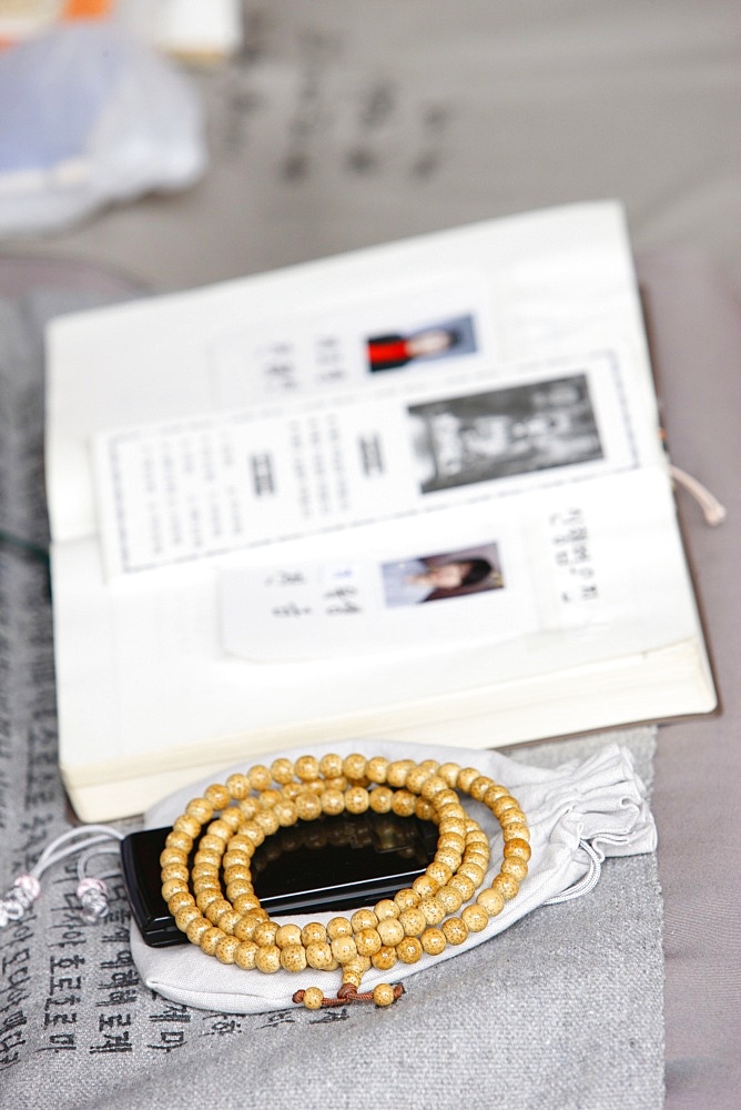 Religious book, prayer beads and mobile phone, Seoul, South Korea, Asia