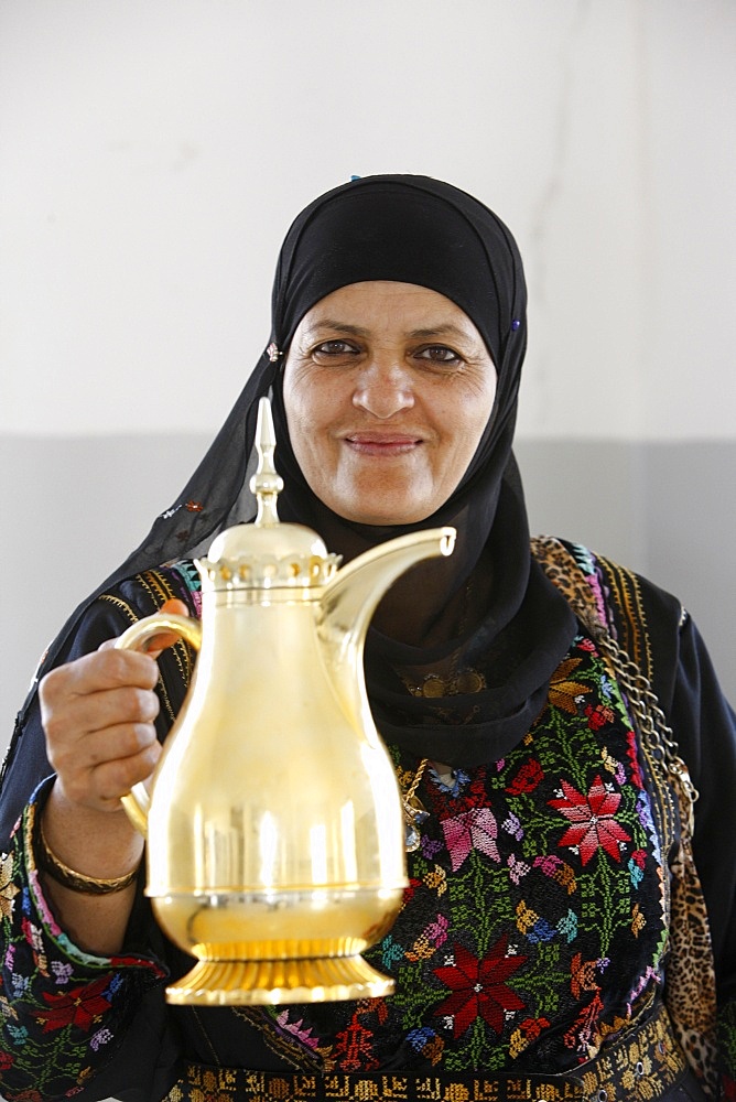 Palestinian volunteer offering coffee at the Physicians for Human Rights' mobile clinic, Souk Ba, Palestine National Authority, Middle East