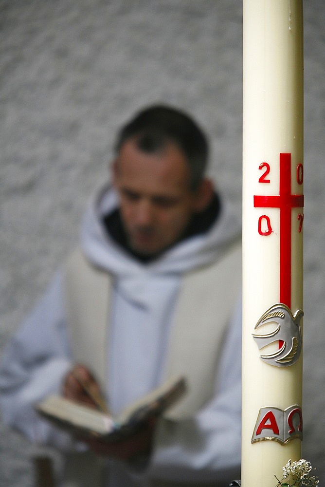 Easter candle and praying monk, Evian, Haute Savoie, France, Europe