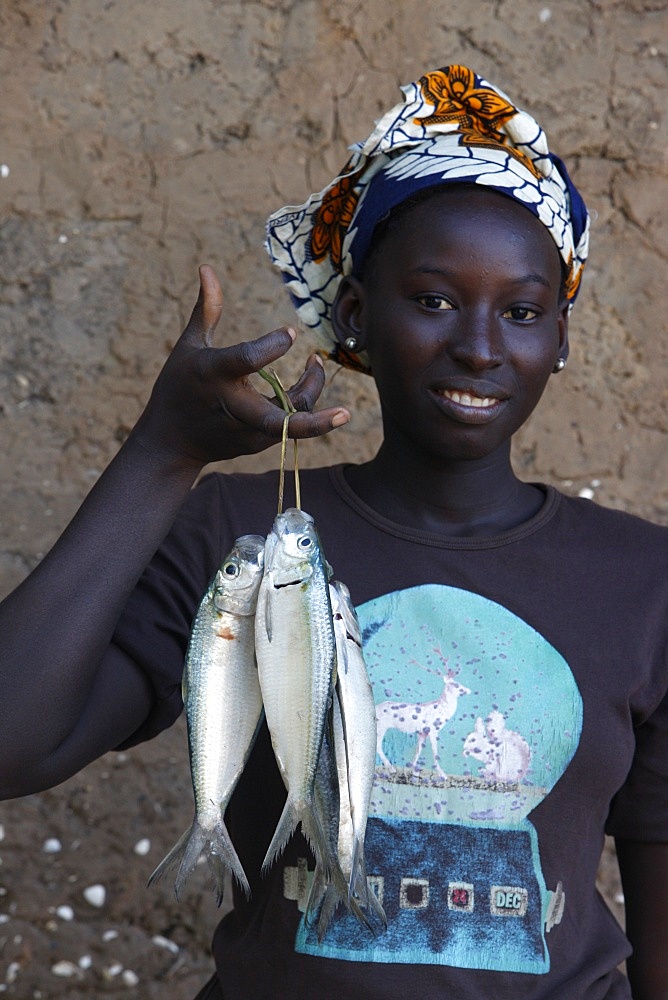 Woman holding fish, Kafountine, Casamance, Senegal, West Africa, Africa