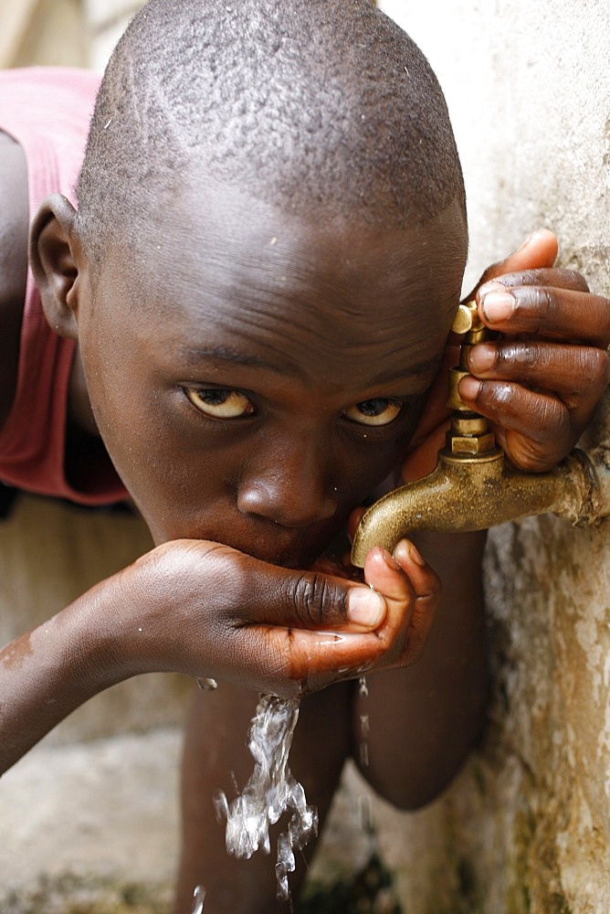 Boy drinking water, Dakar, Senegal, West Africa, Africa