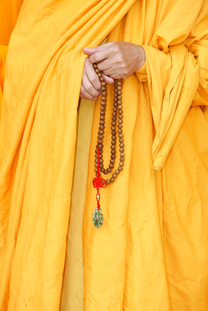 Buddhist monk holding prayer beads, Thiais, Val de Marne, France, Europe