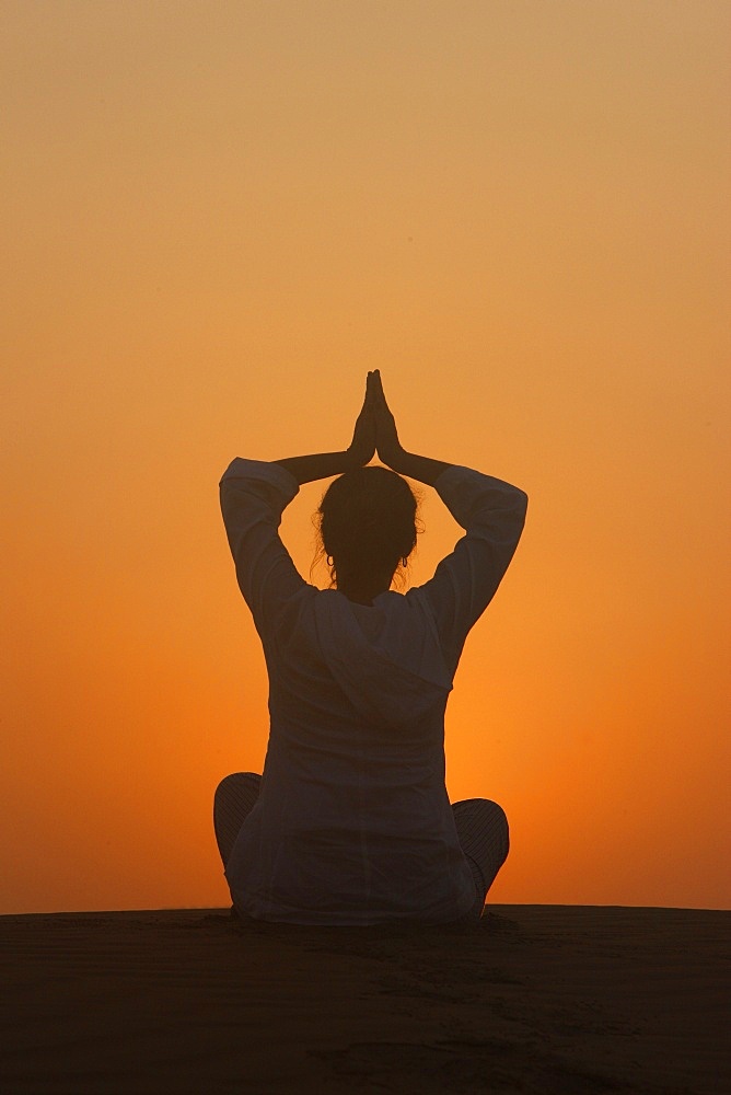 Sunset meditation in the desert, Abu Dhabi, United Arab Emirates, Middle East