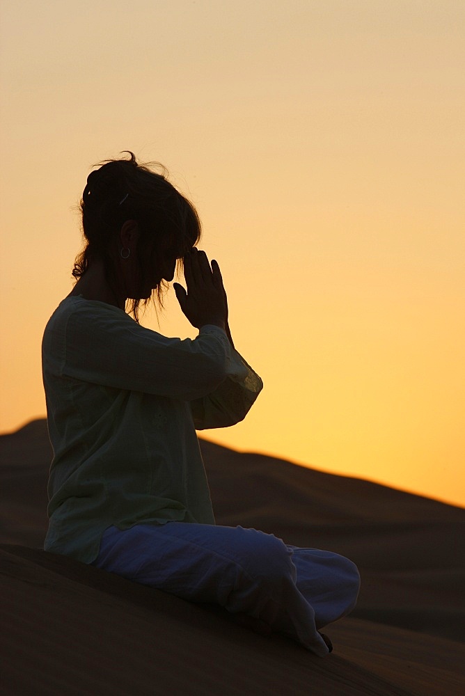 Sunset meditation in the desert, Abu Dhabi, United Arab Emirates, Middle East