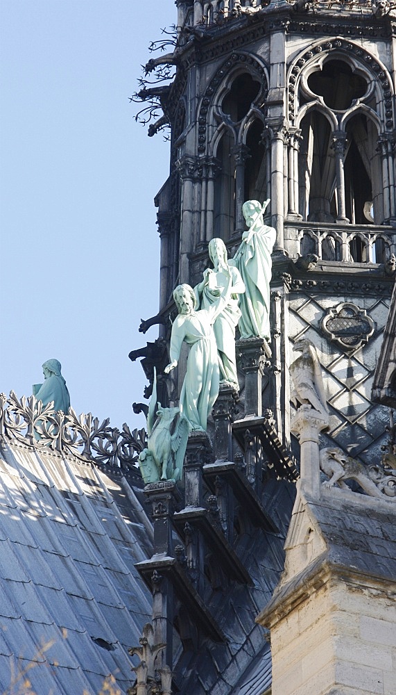 Statues of three apostles at the foot of Notre-Dame-De-Paris cathedral spire, Paris, Ile de France, France, Europe