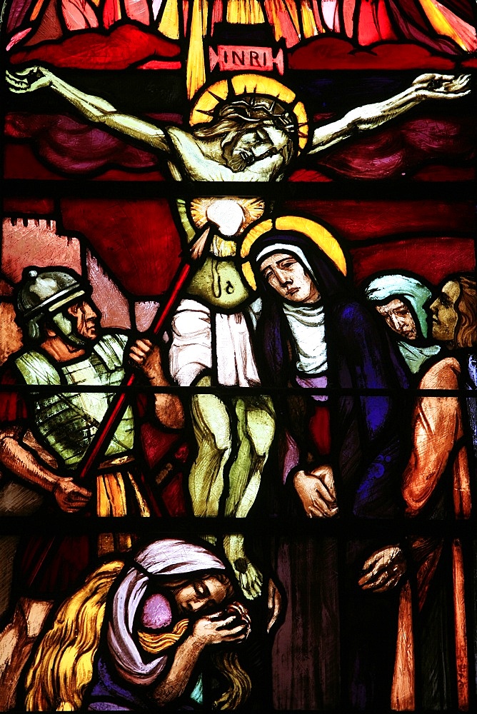 Stained glass of Christ on the cross, in Saint-Pierre de Solesmes Abbey, Solesmes, Sarthe, Pays de la Loire, France, Europe