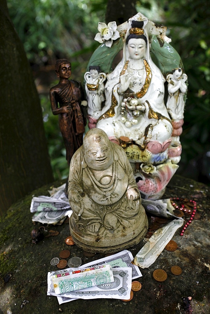 Money offering and statues in the garden of Buddhapadipa temple, Wimbledon, London, England, United Kingdom, Europe