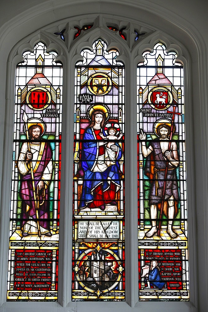 Stained glass window by Lawrence Lee showing the Virgin Mary and Child flanked by St. Thomas and St. John the Baptist with a roundel of the church tower and kneeling figure of Christopher Wren below, South Chapel, St. Mary Aldermary Church, City of London, London, England, United Kingdom, Europe