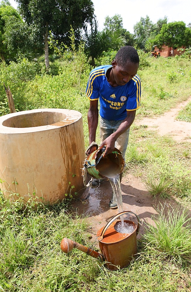 Man fetching water from well, Tori, Benin, West Africa, Africa