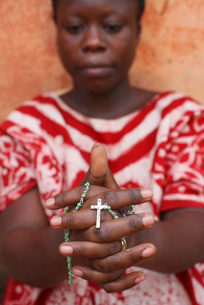 African woman praying the rosary, Lome, Togo, West Africa, Africa