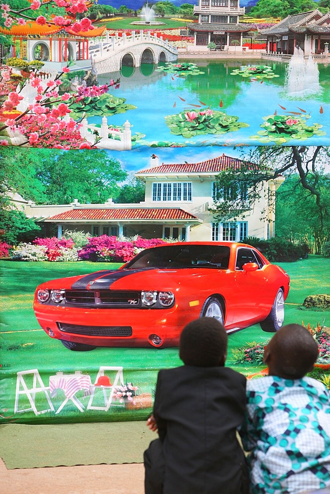 African boys dreaming in front of a poster, Lome, Togo, West Africa, Africa