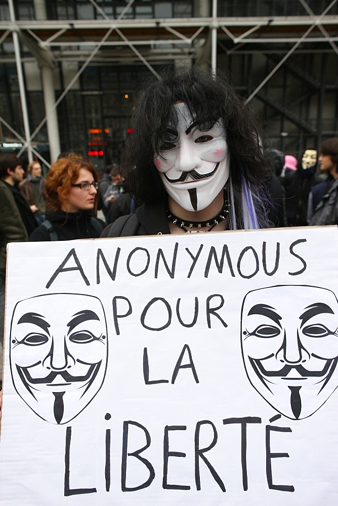 Protestor wearing Guy Fawkes mask, trademark of the Anonymous movement and based on a character in the film V for Vendetta, Paris, France, Europe