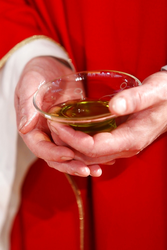 Catholic priest holding sacred oil, Seine-Saint-Denis, France, Europe