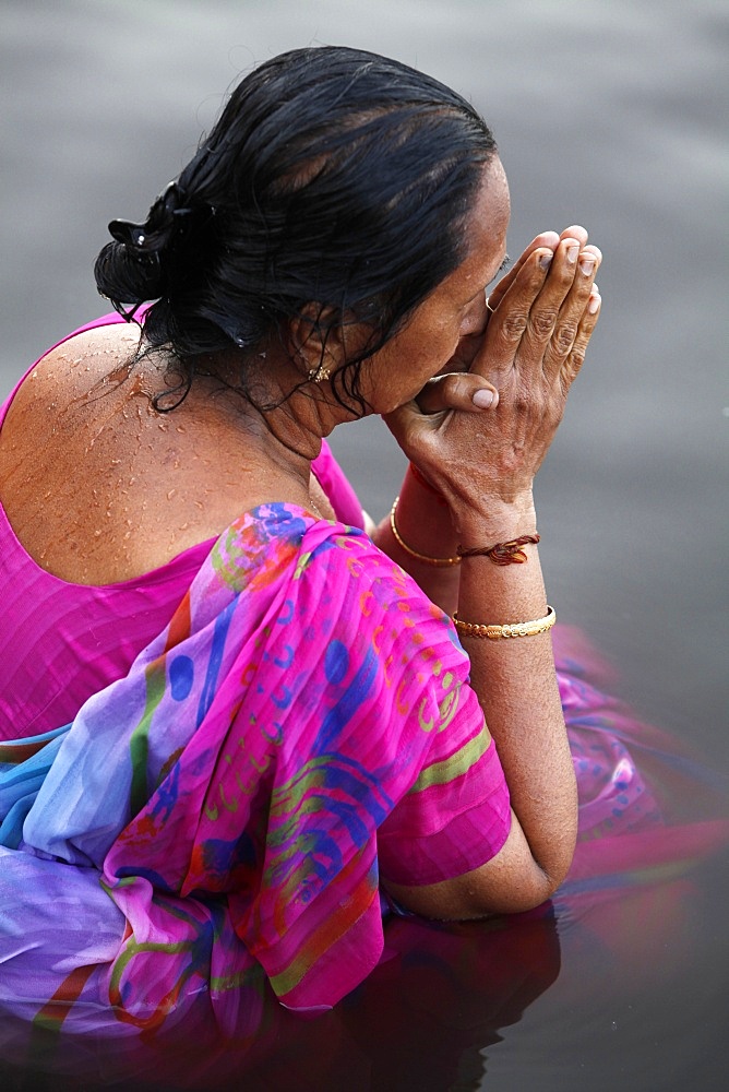 Hindu woman praying in the Yamuna River, Mathura, Uttar Pradesh, India, Asia