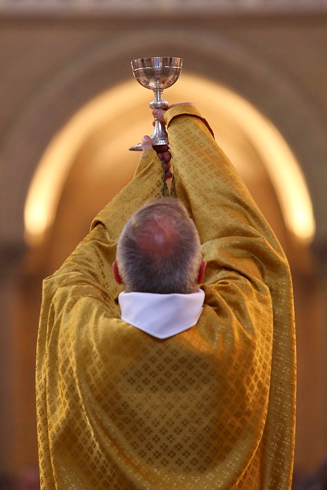 Priest during Eucharist celebration, Paris, France, Europe