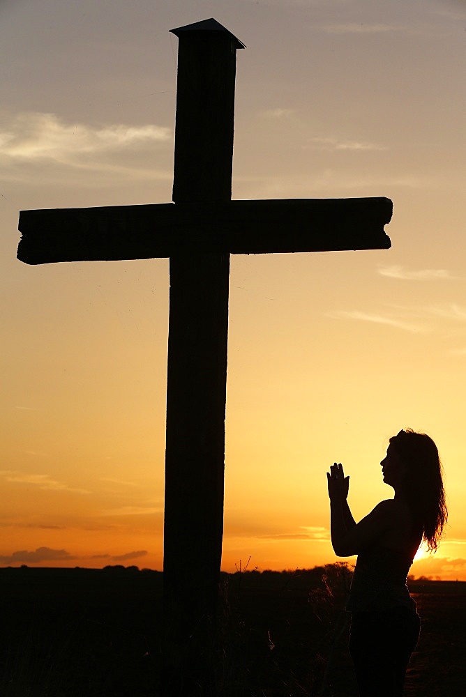 Woman praying at sunset, Cher, France, Europe