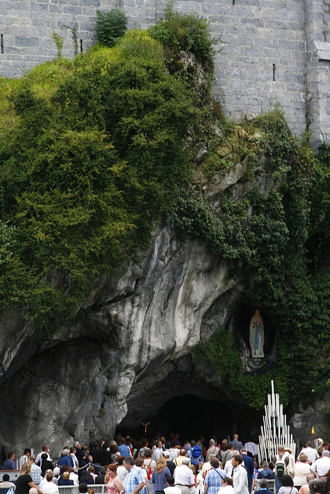 Pilgrims outside the Lourdes grotto, Lourdes, Hautes Pyrenees, France, Europe