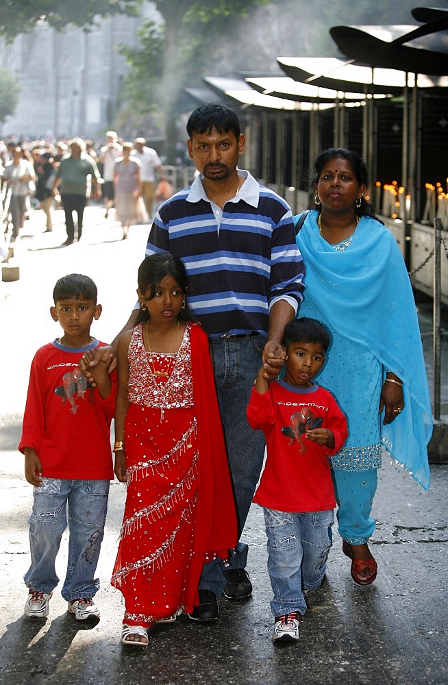 Tamil family at the Lourdes shrine, Lourdes, Hautes Pyrenees, France, Europe