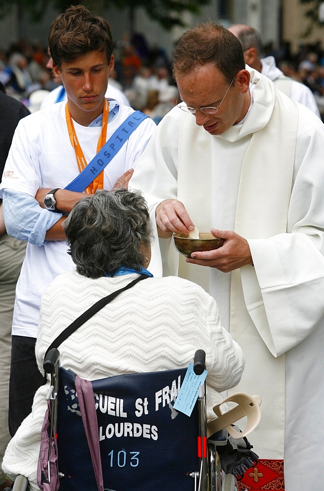 Disabled woman receiving Holy Communion, Lourdes, Hautes Pyrenees, France, Europe