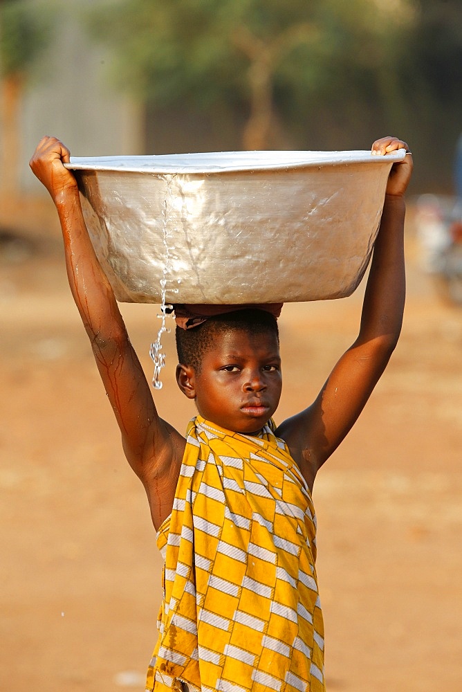 Water chore in an African village, Togo, West Africa, Africa