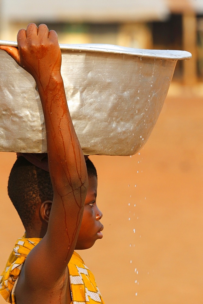 Water chore in an African village, Togo, West Africa, Africa