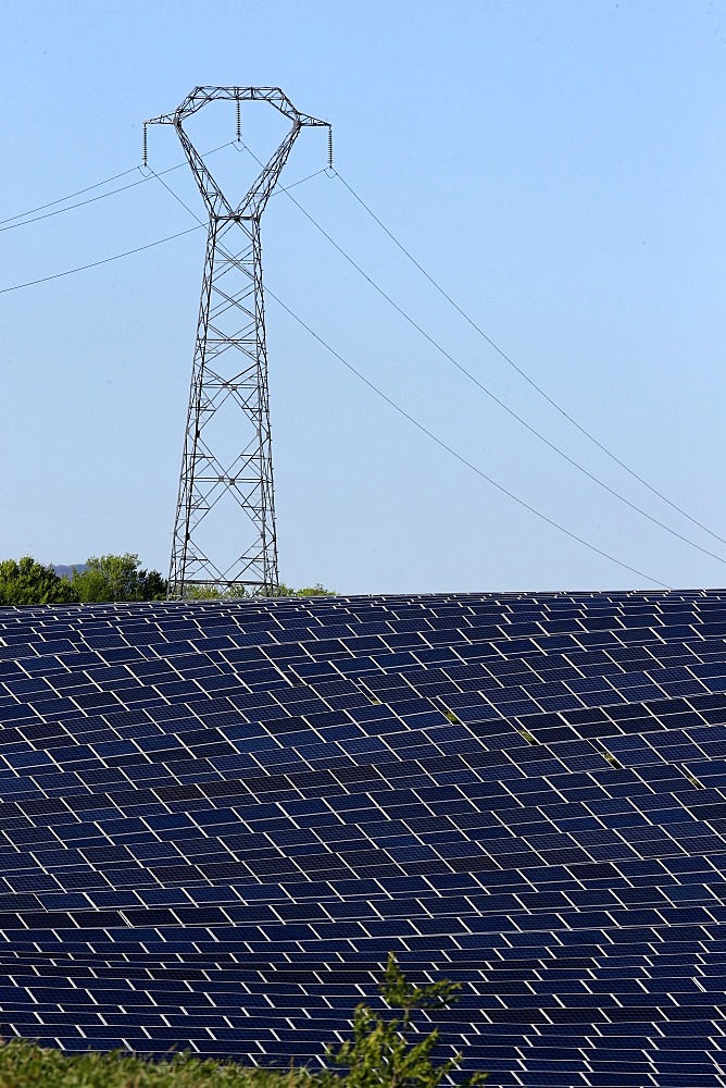 Solar farm, Photovoltaic power plant and pylon, Alpes-de-Haute-Provence, France, Europe