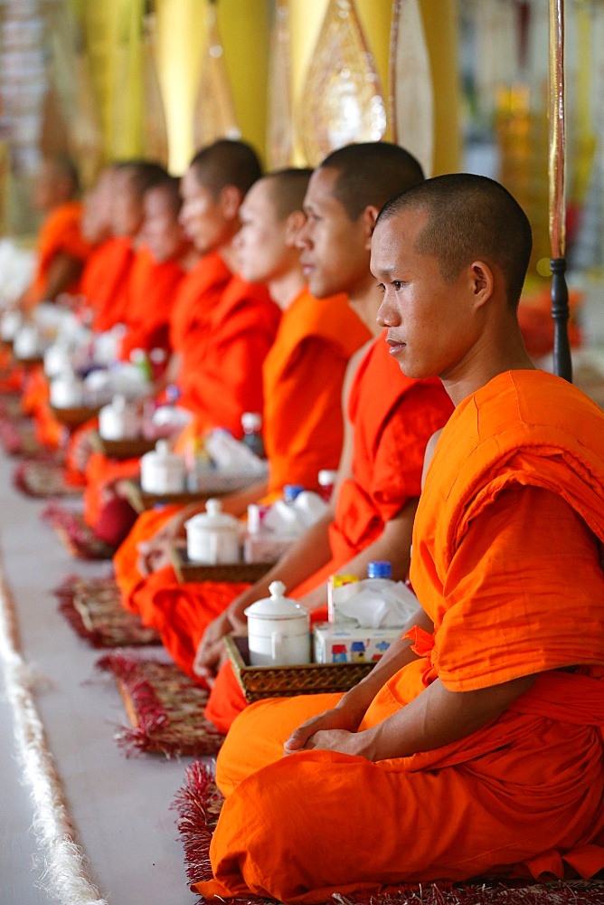 Seated Buddhist monks chanting and reading prayers at a ceremony, Wat Ong Teu Buddhist Temple, Vientiane, Laos, Indochina, Southeast Asia, Asia