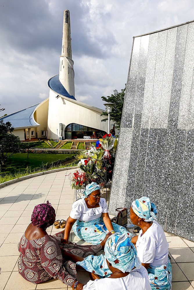 Pilgrims praying and joining hands at Our Lady of Africa Catholic sanctuary, Abidjan, Ivory Coast, West Africa, Africa