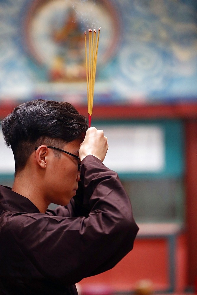 Mariamman Hindu Temple, worshipper praying with incense sticks, Ho Chi Minh City, Vietnam, Indochina, Southeast Asia, Asia