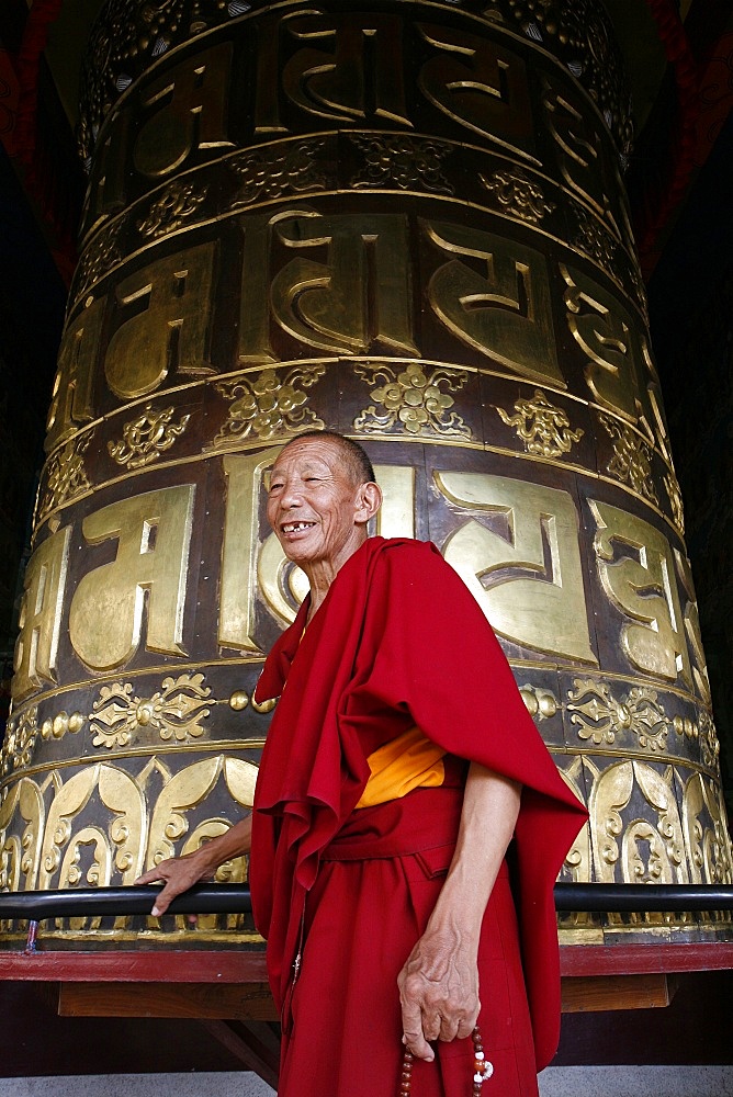 Old man and prayer wheel, Kopan Monastery, Kathmandu, Nepal, Asia