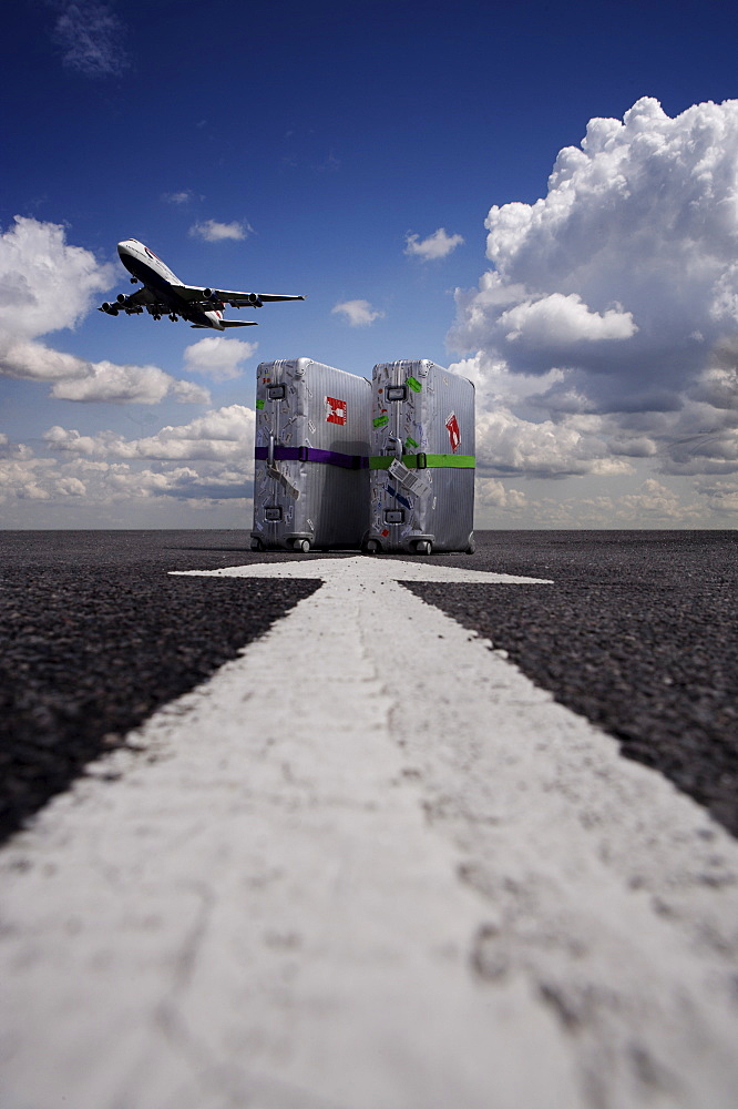 Suitcases with aircraft taking off