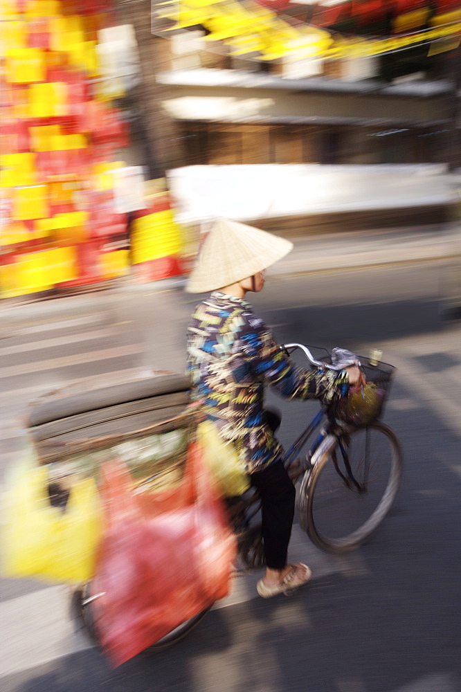 Man on bike at Tet festival (Vietnamese New Year), Ho Chi Minh city, Vietnam, Indochina, Southeast Asia, Asia