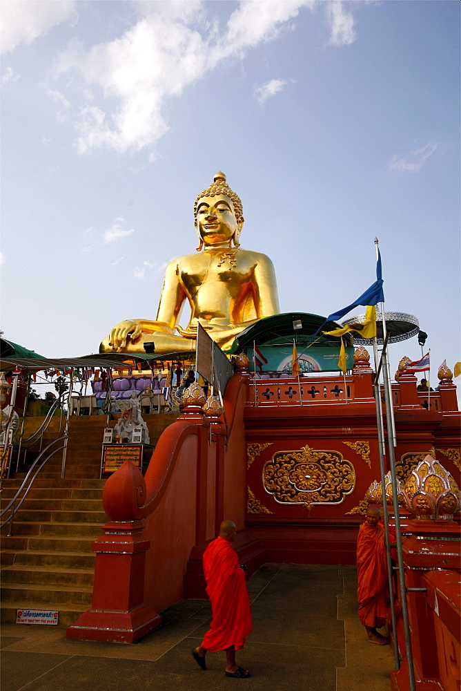 Two monks below the giant Buddha in the Sop Ruak temple, near the border with Laos and Burma, Thailand, Southeast Asia, Asia