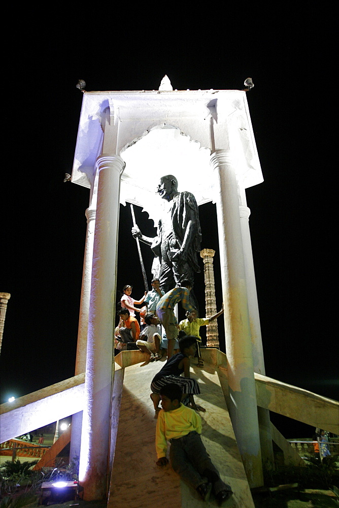 Under the statue of Mahatma Gandhi on the sea front of Pondicherry, Tamil Nadu, India, Asia