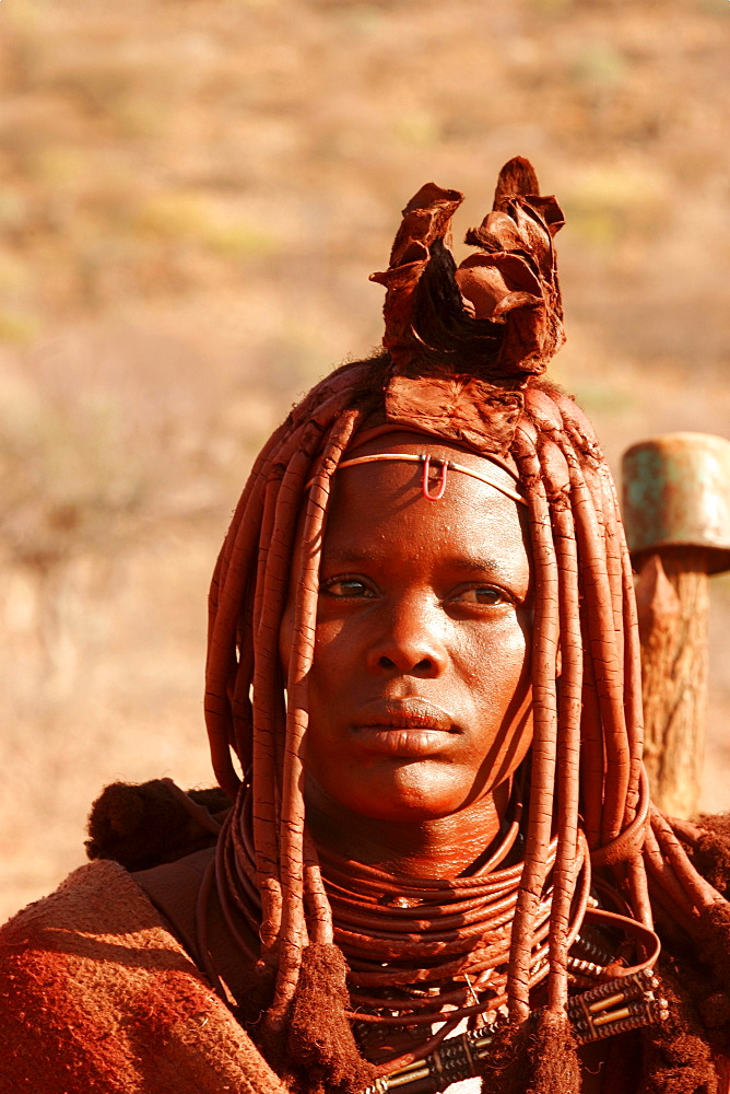 Young Himba woman wearing wedding finery, near to the Epupa falls on the border with Angola, Namibia, Africa