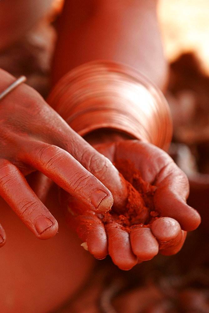 Himba women cover their body with a mix of powder, ground, argil and resin, Namibia, Africa