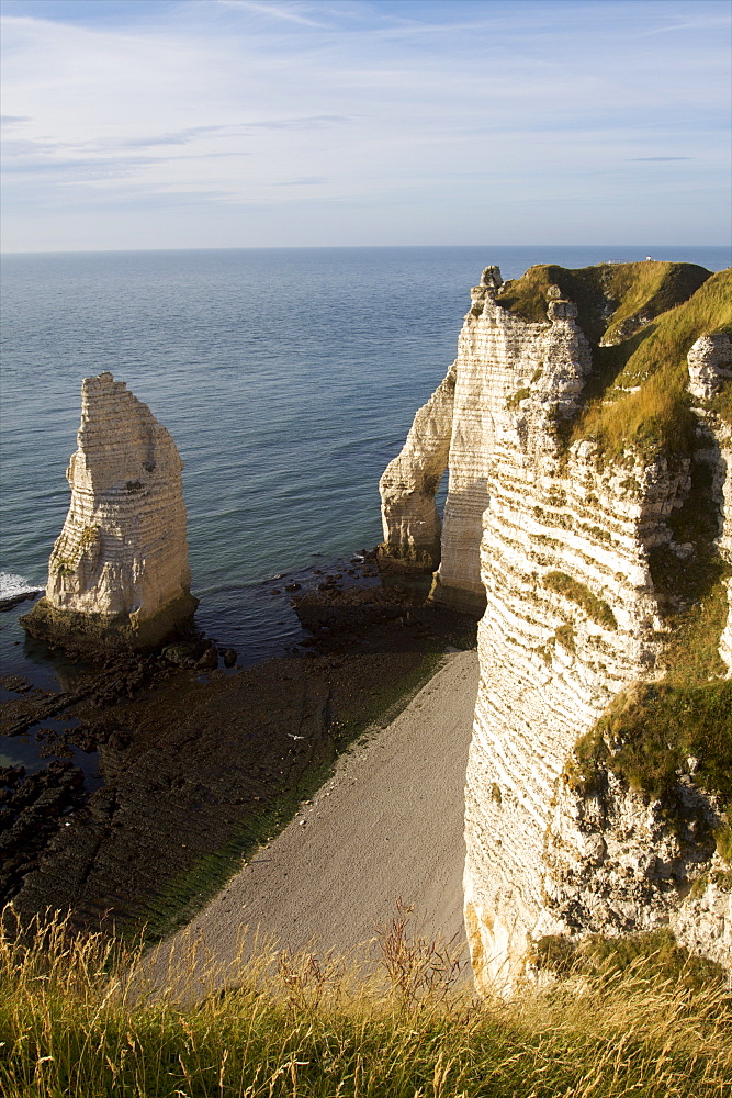 The pebble beach of the Aiguille of Etretat and the cliffs of the Cote d'Albatre, Seine Maritime, Normandy, France, Europe