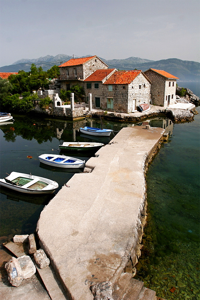 Typical houses with tiled roofs and stone walls on the Gulf of Kotor, Montenegro, Europe