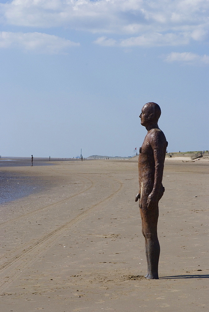 Some of the 100 iron men at Crosby Beach as part of Antony Gormley's Another Place, Liverpool, Merseyside, England, United Kingdom, Europe