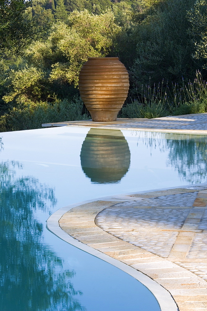 Infinity pool and terracotta urn, Kerkyra, Corfu, Ionian Islands, Greek Islands, Greece, Europe