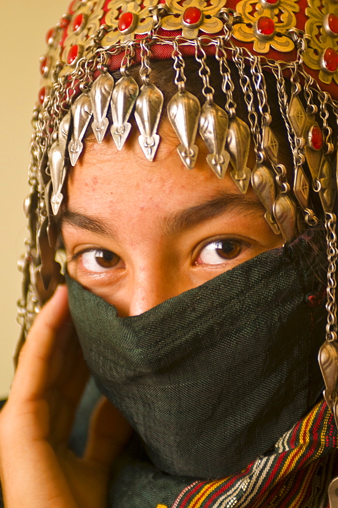 Traditionally dressed young girl behind a veil, Ashgabad, Turkmenistan, Central Asia, Asia