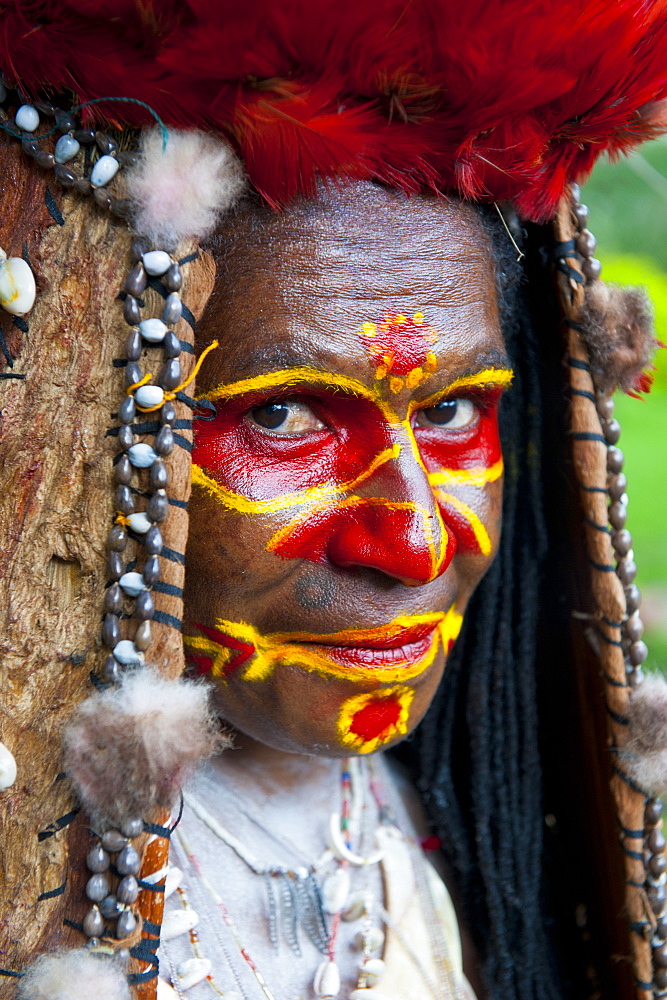 Colourfully dressed and face painted local tribal woman celebrating the traditional Sing Sing in Paya, Papua New Guinea, Pacific