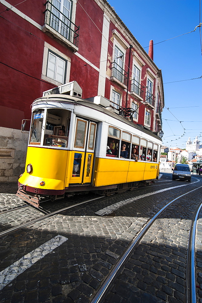 Famous tram 28 going through the old quarter of Alfama, Lisbon, Portugal, Europe