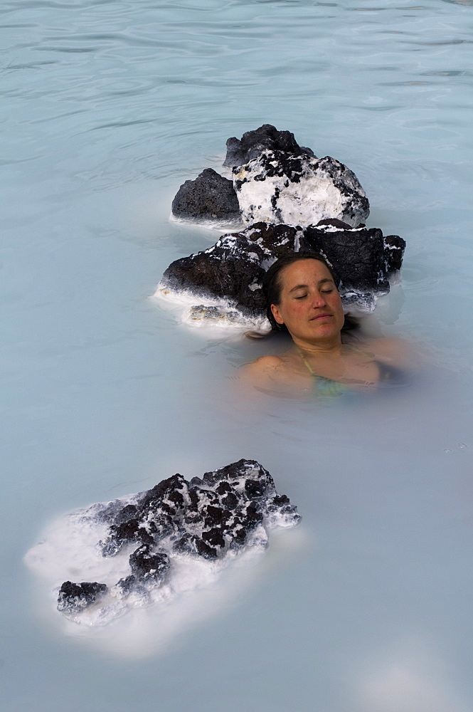 Young woman enjoying bathing in hot spring, Blue Lagoon, Iceland, Polar Regions