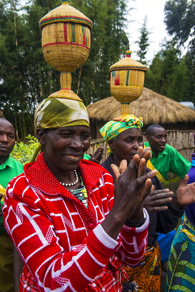 Women carrying baskets on their heads at a ceremony of former poachers, in the Virunga National Park, Rwanda, Africa